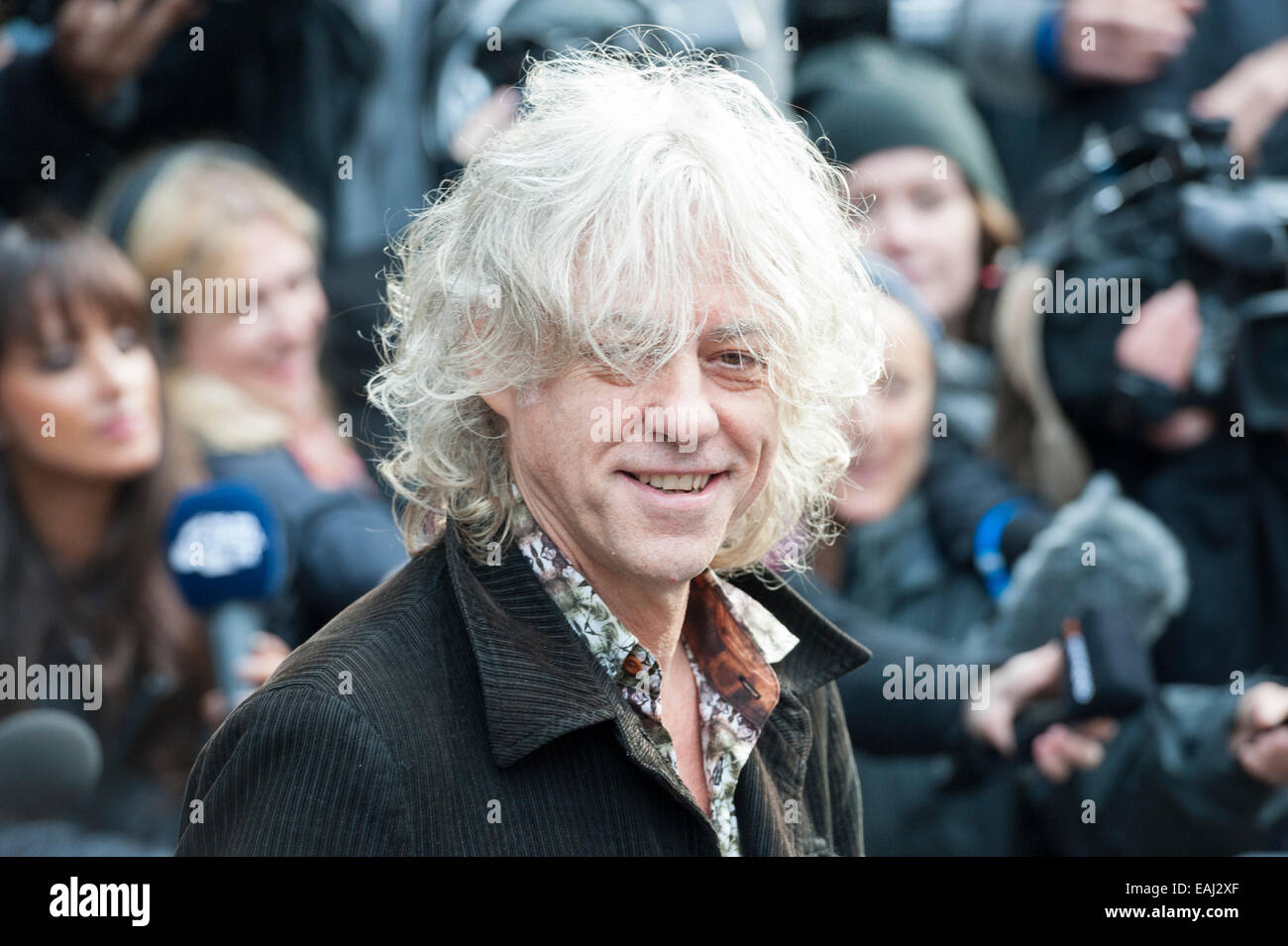 Basing Street, London, UK. 15th November 2014. Artists arrive at Sarm Studios in Notting Hill, west London, to record Band Aid. Pictured: Bob Geldof greets the crowd outside Sarm Studios. Credit:  Lee Thomas/Alamy Live News Stock Photo