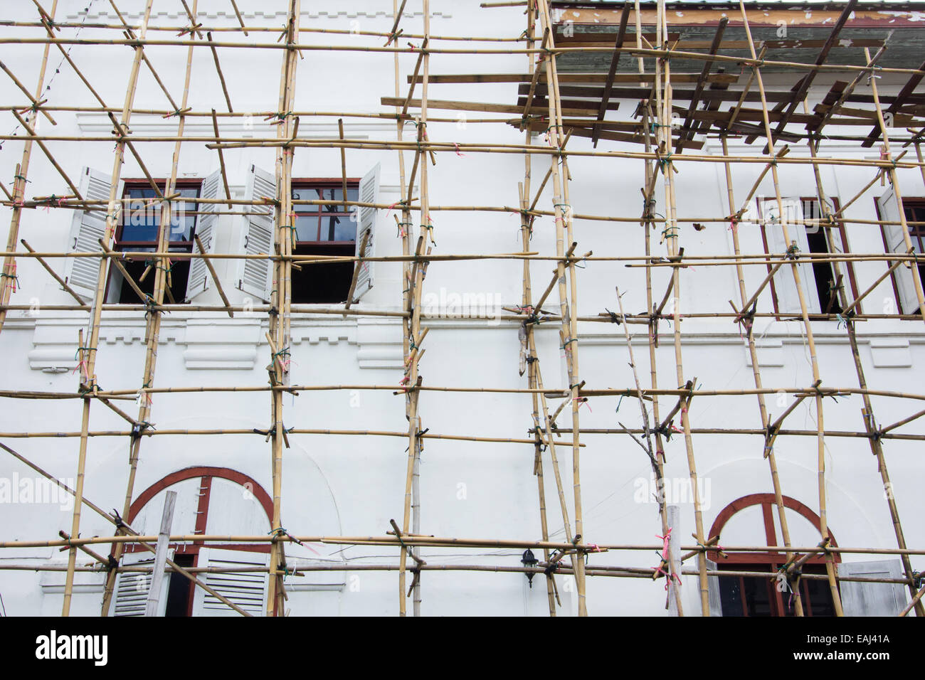 Wooden scaffolding around new building in Thailand Stock Photo
