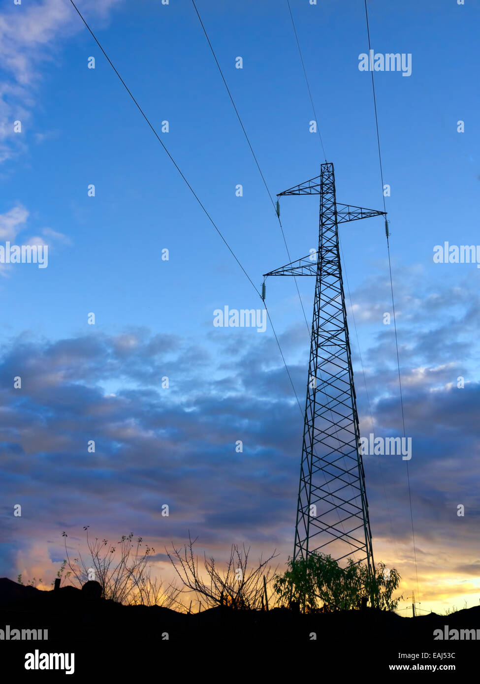 Electricity power pylon and lines at sunset Stock Photo - Alamy