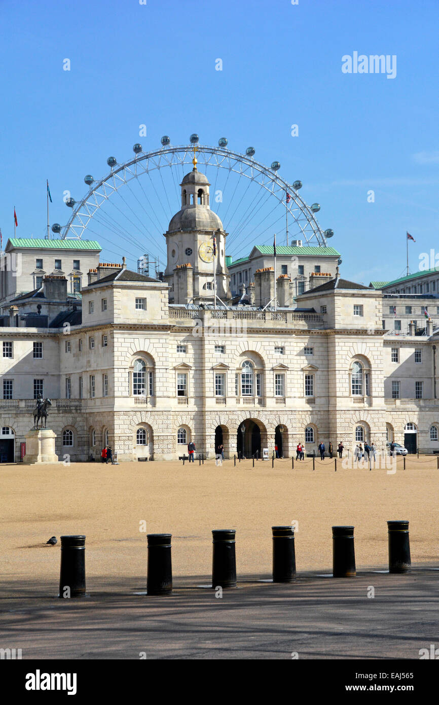 Horse Guards buildings and the Parade Ground behind Whitehall with security bollards and The London Eye ferris wheel beyond Stock Photo