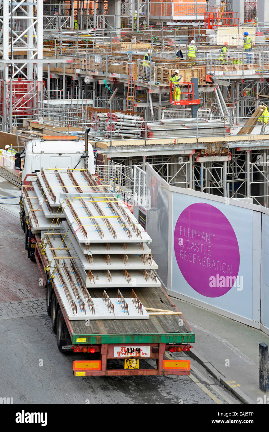 Large 'Elephant and Castle Regeneration' sign on construction site hoarding with lorry arriving with flooring panels Stock Photo