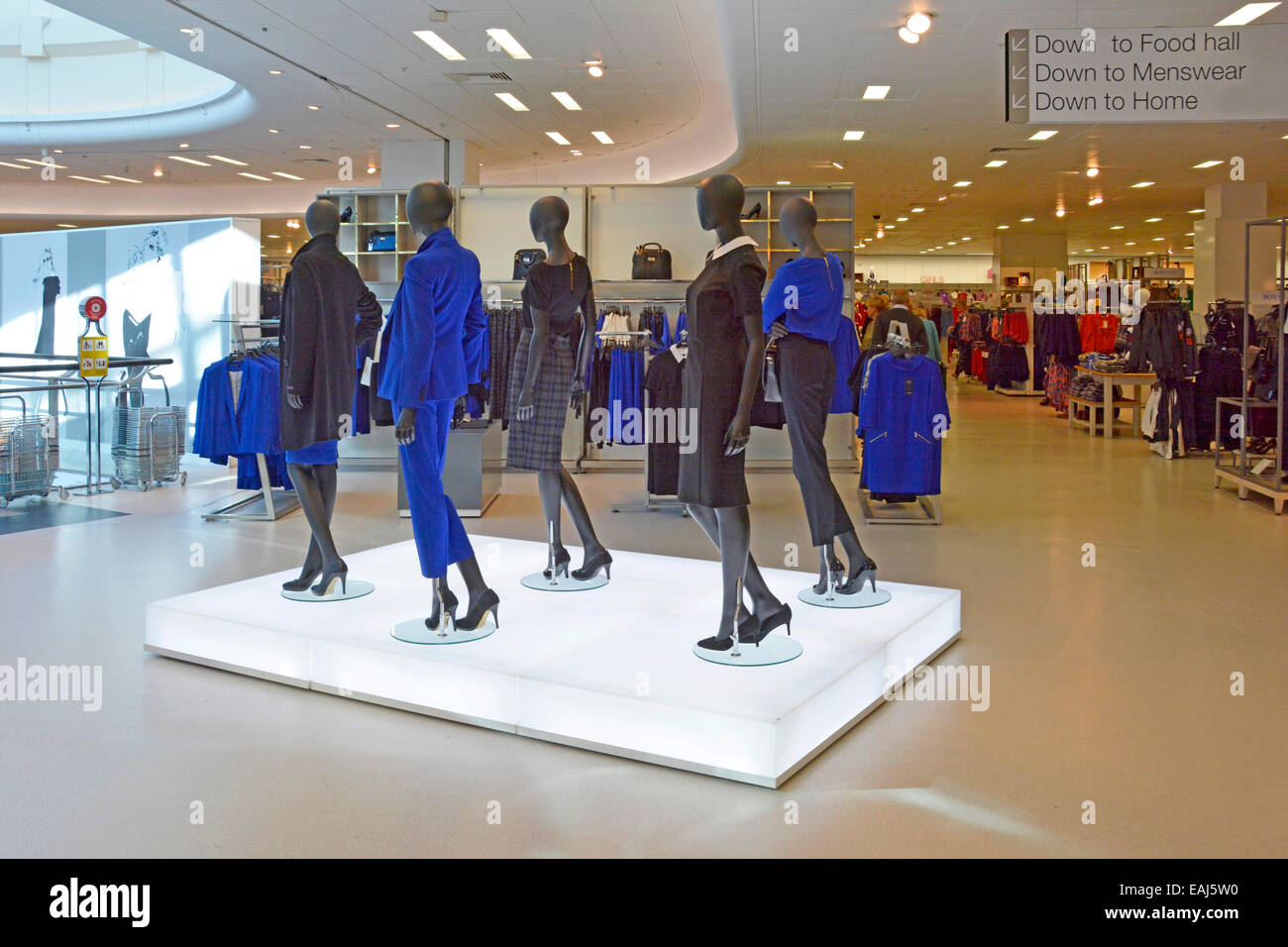 Interior of Marks and Spencer store with illuminated pedestal displaying ladies fashions on mannequins Essex England UK Stock Photo