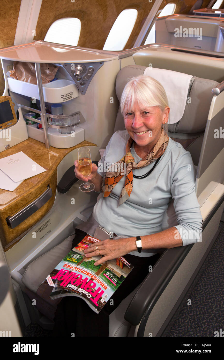 Emirates Airline, female A380 Business Class passenger with champagne Stock Photo