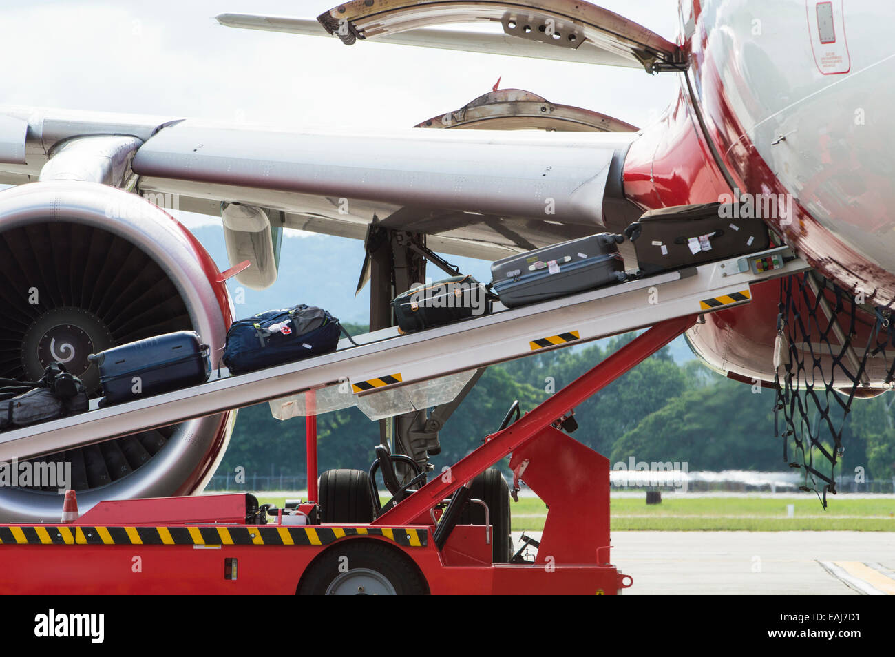 Loading luggage to commercial airplane Stock Photo
