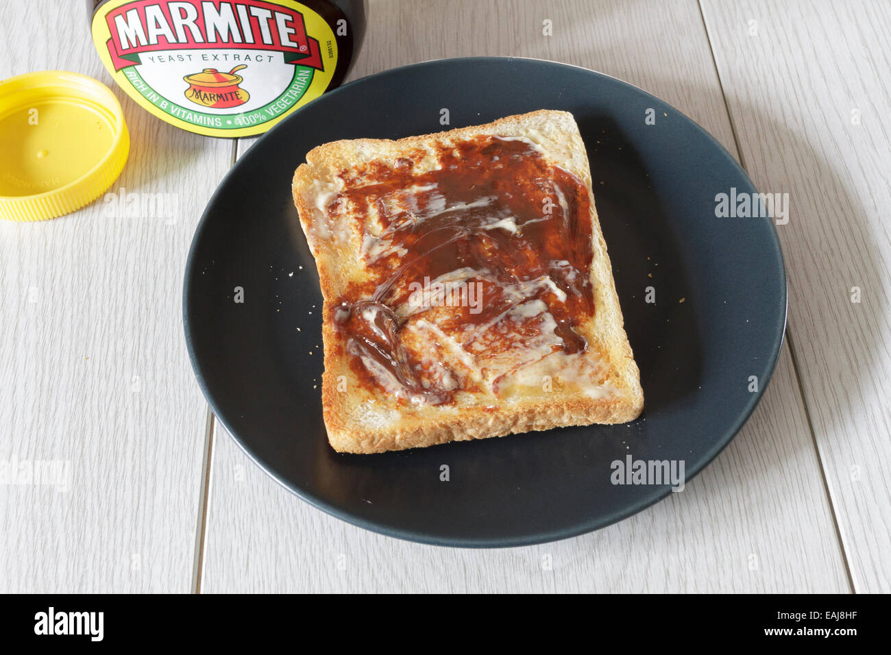 Single piece of hot toast with butter and marmite Stock Photo Alamy
