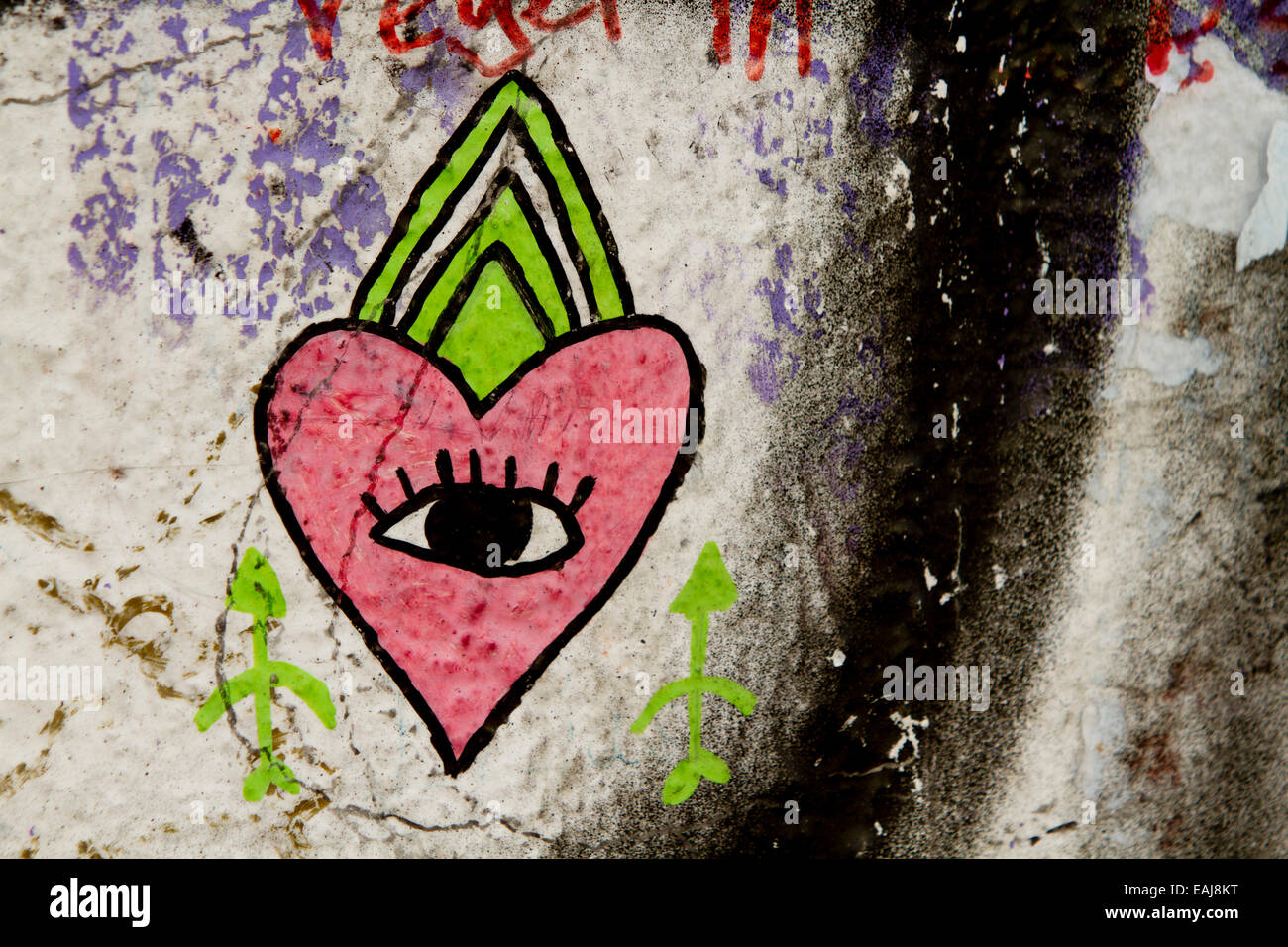 Graffiti street art Berlin wall tags eye heart Stock Photo