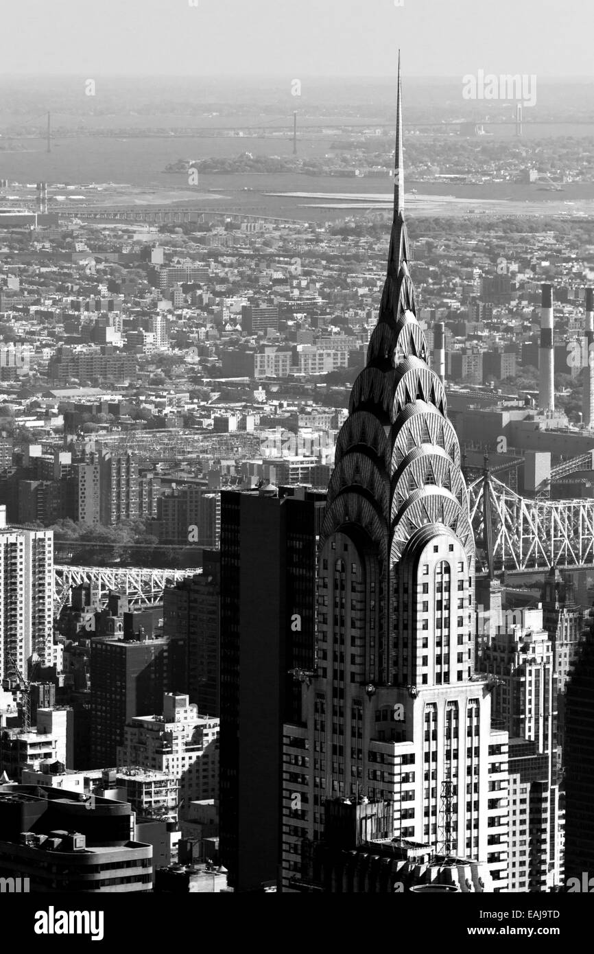 The Chrysler Building New York city overlooking the lower east side and a bridge in the background photographed in monochrome Stock Photo