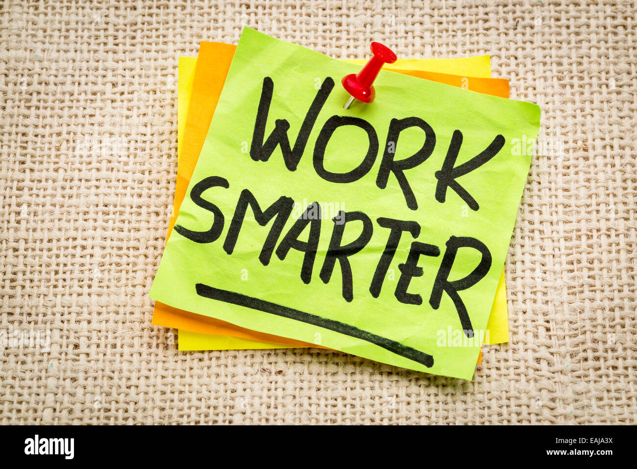 work smarter reminder on a green sticky note against burlap canvas Stock Photo
