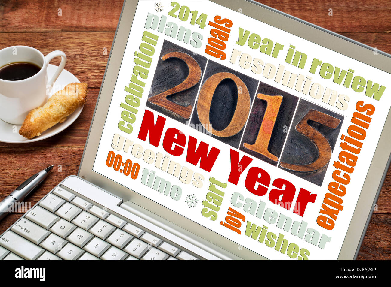 2015 New Year concept - word cloud on a laptop screen with a cup of coffee Stock Photo
