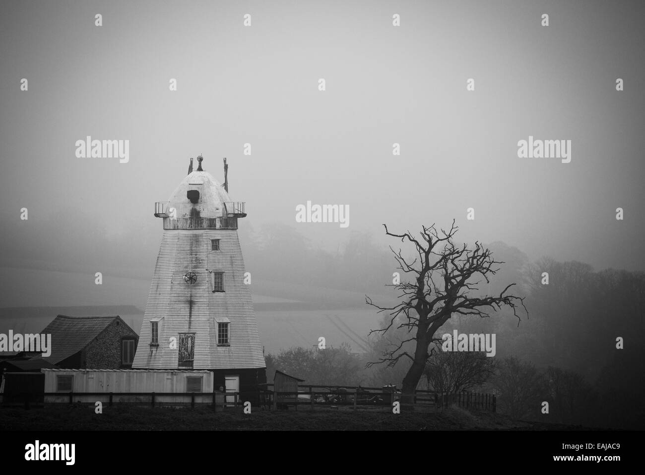 The old  lower windmill, near Dalham in Suffolk, England on a misty rainy day in November. Stock Photo