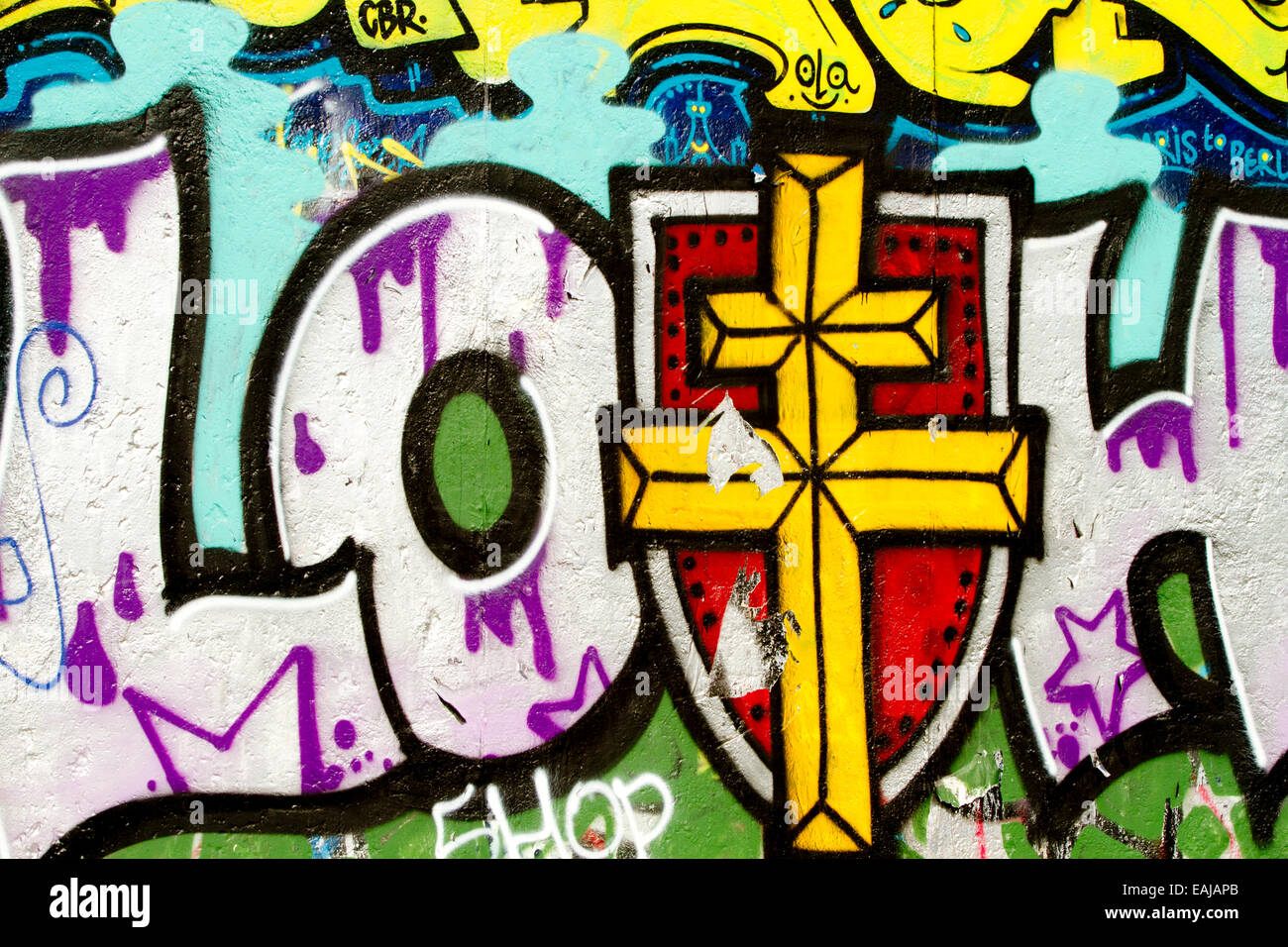 Graffiti tag art urban Berlin Wall loth cross Stock Photo