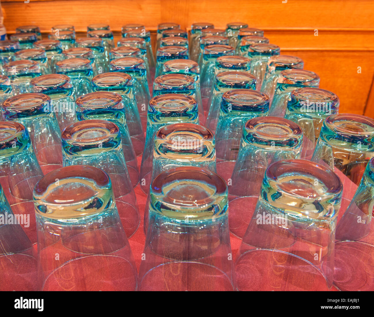 Abstract closeup with rows of drinking glasses upside down on a red table Stock Photo Alamy
