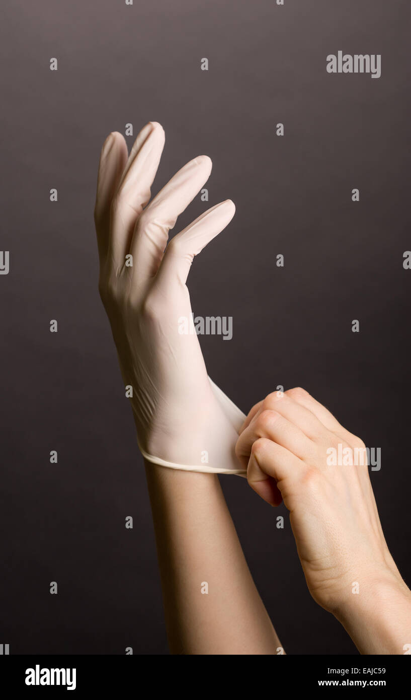 Putting on latex gloves Stock Photo Alamy
