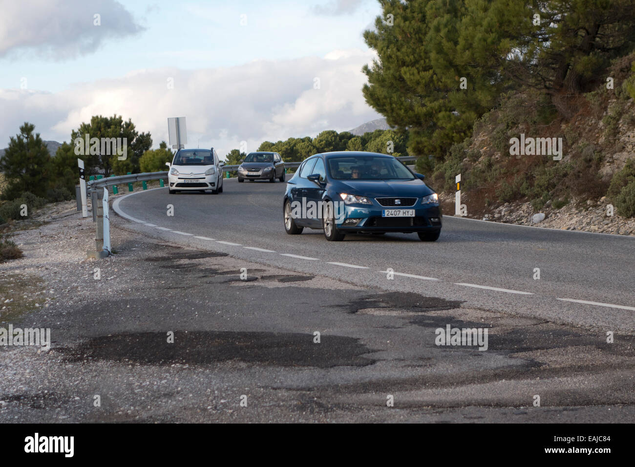 Three Cars Seat Renault driving a winding road curve in mountains of Ronda, Southern Spain. Stock Photo
