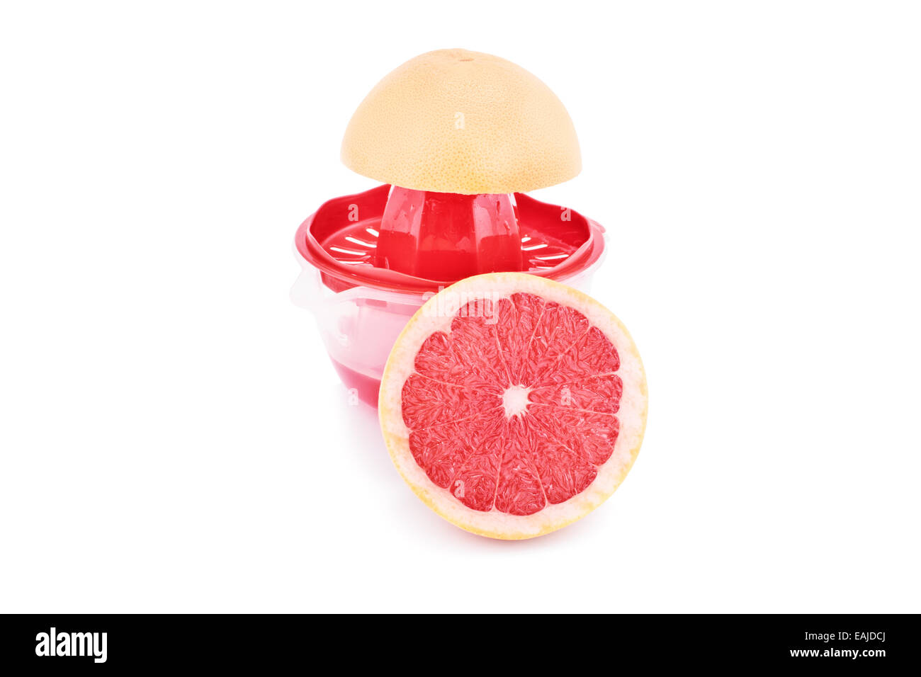 Half filled squeezer with citrus slices, isolated on white background. Making fresh grapefruit juice. Stock Photo