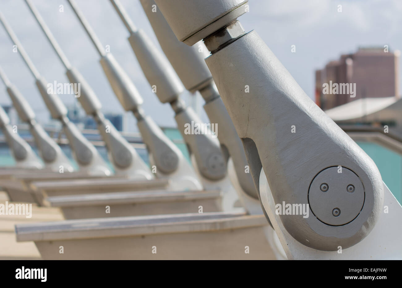 A close-up of the steel cable-stays of the Media City footbridge in Salford Quays, taken from a low angle with shallow focus. Stock Photo