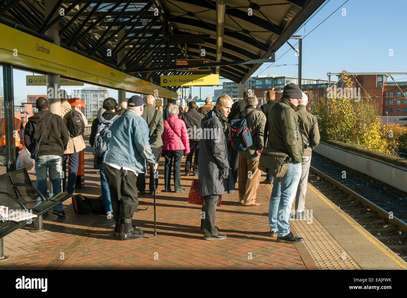 Passengers waiting at the Cornbrook Metrolink tram stop, Manchester