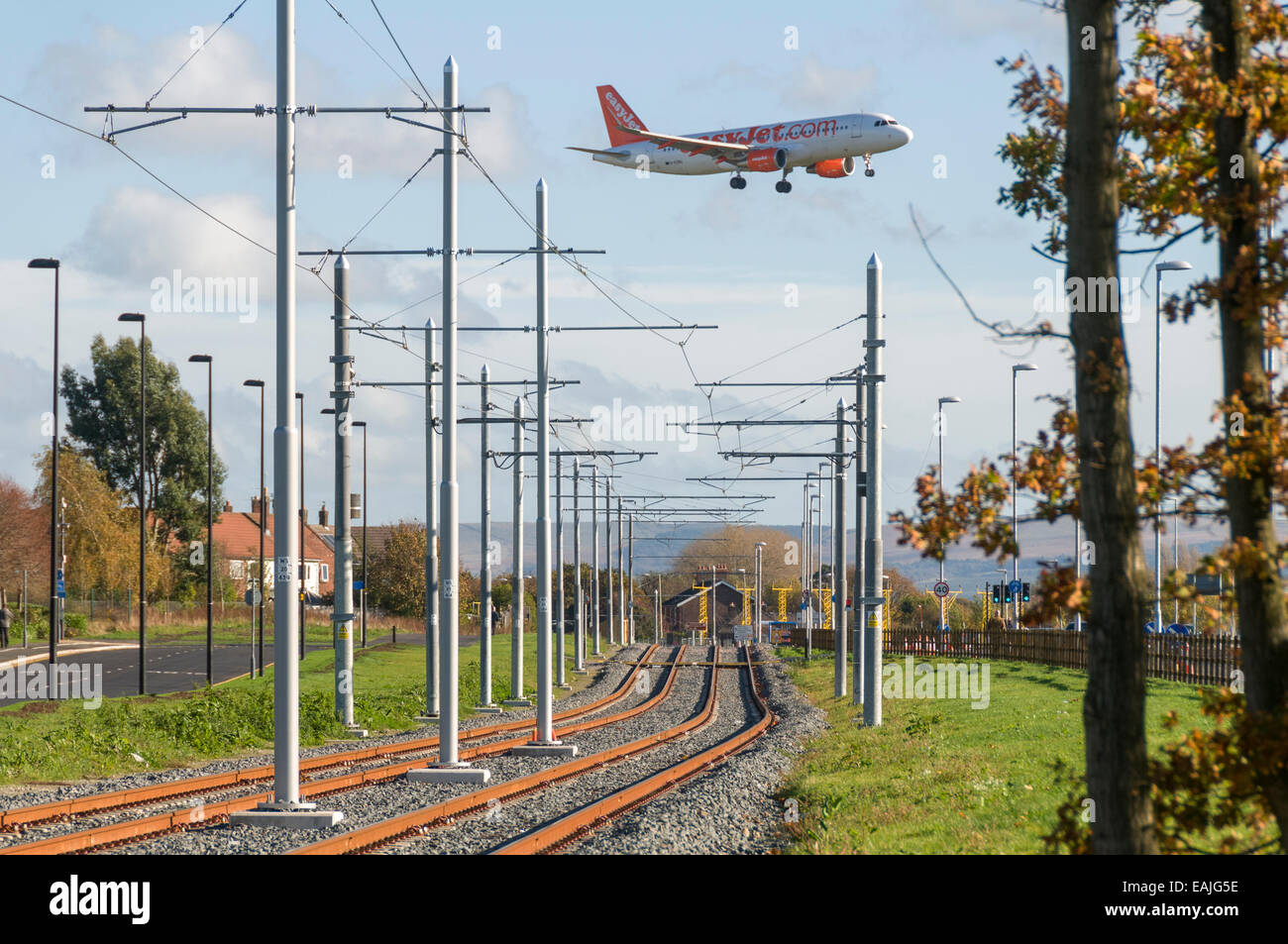 Aircraft above Metrolink tram tracks, on the Airport Line near