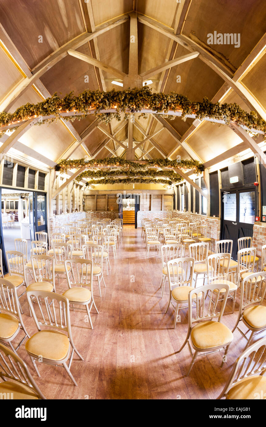 A civil wedding ceremony location in a converted agricultural building, with seating and decorations Stock Photo