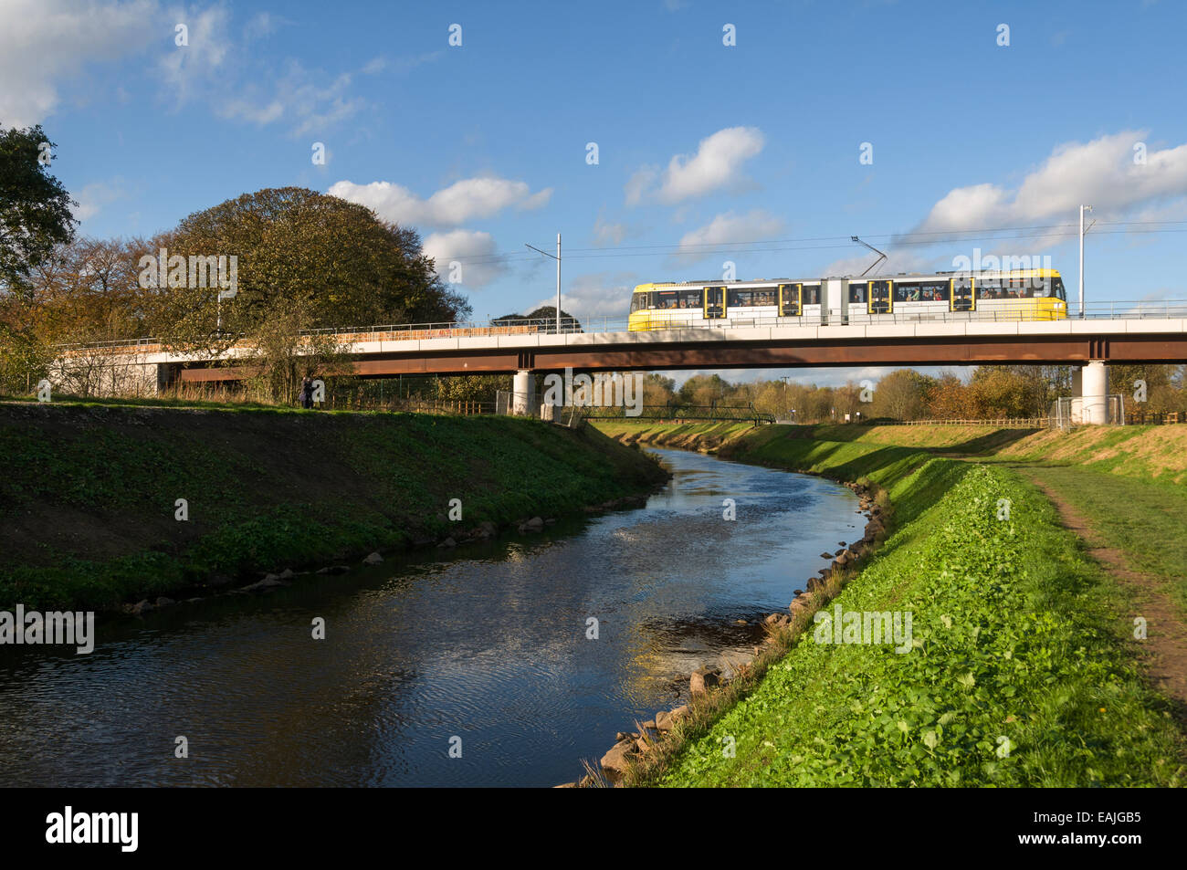 Metrolink tram on the river Mersey viaduct near Jackson's Boat, Airport Line, Manchester, England, UK Stock Photo