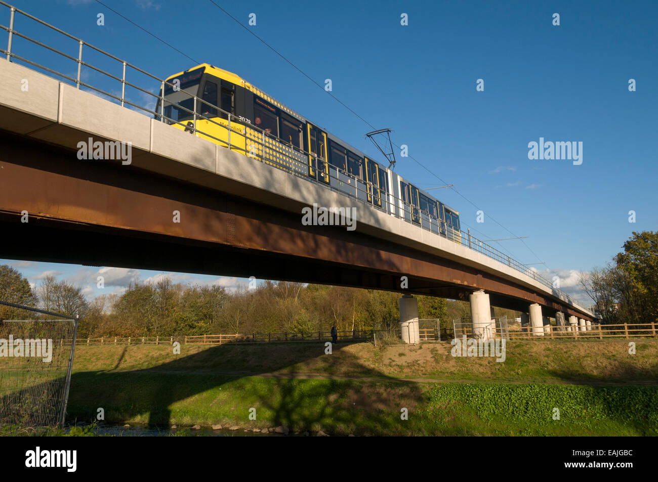 Metrolink tram on the river Mersey viaduct near Jackson's Boat, Airport Line, Manchester, England, UK Stock Photo