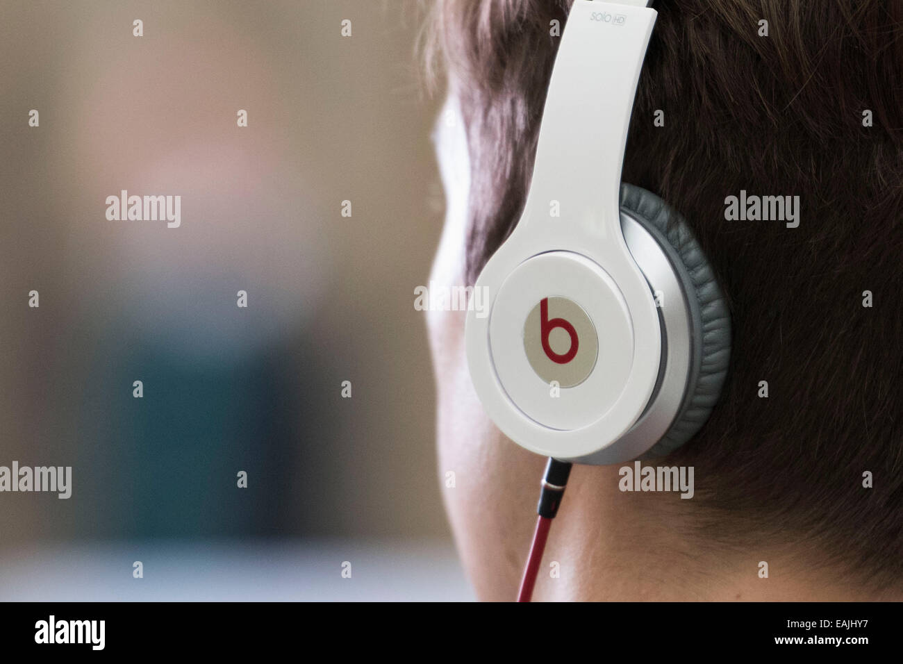 A young male boy wears Beats by Dr Dre headphones. Stock Photo