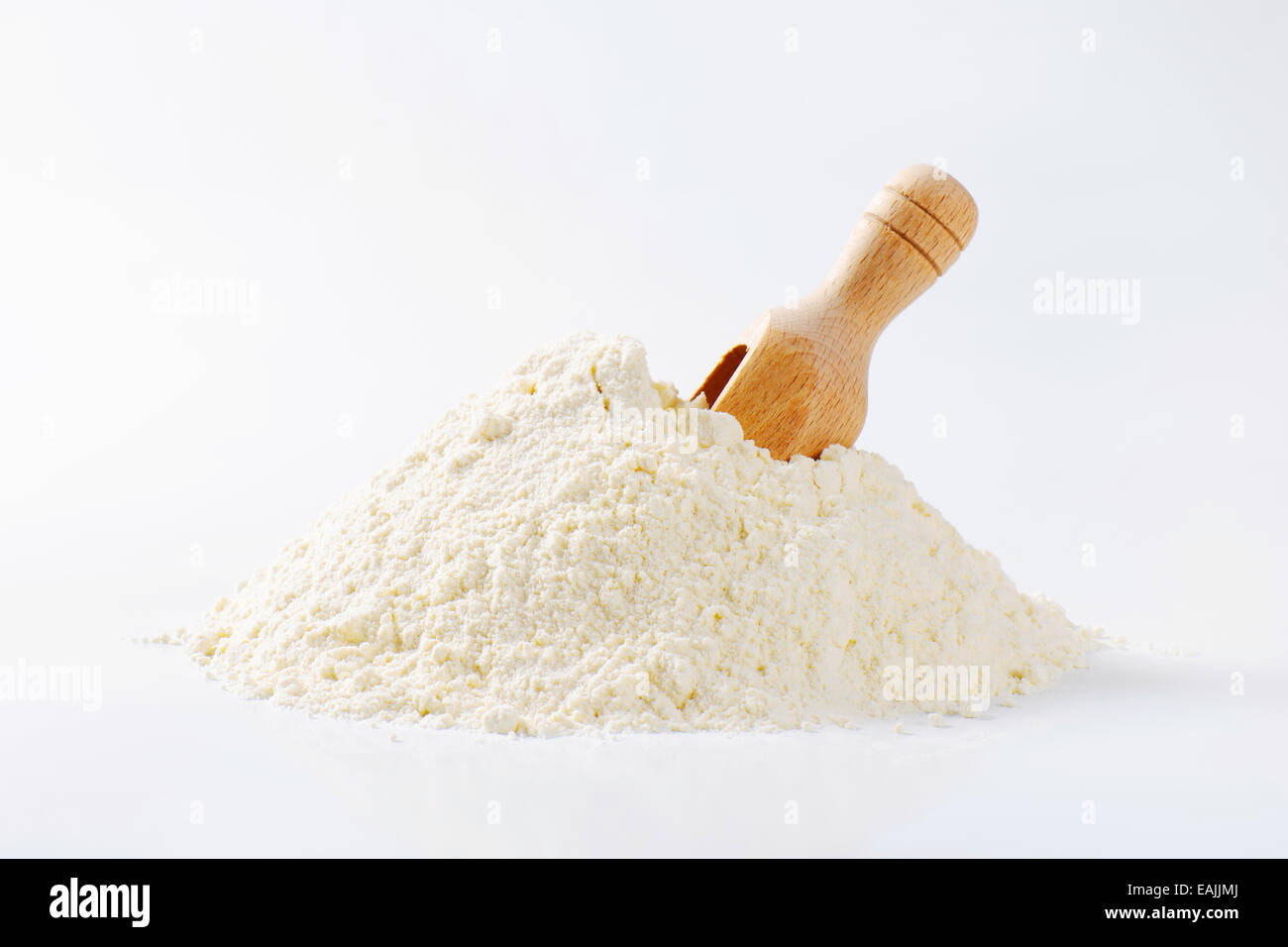 Pile of finely ground flour and wooden scoop Stock Photo