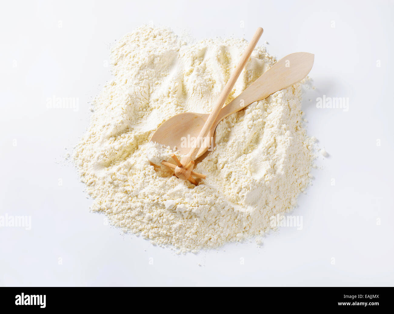 Finely ground flour, wooden beater and spoon Stock Photo