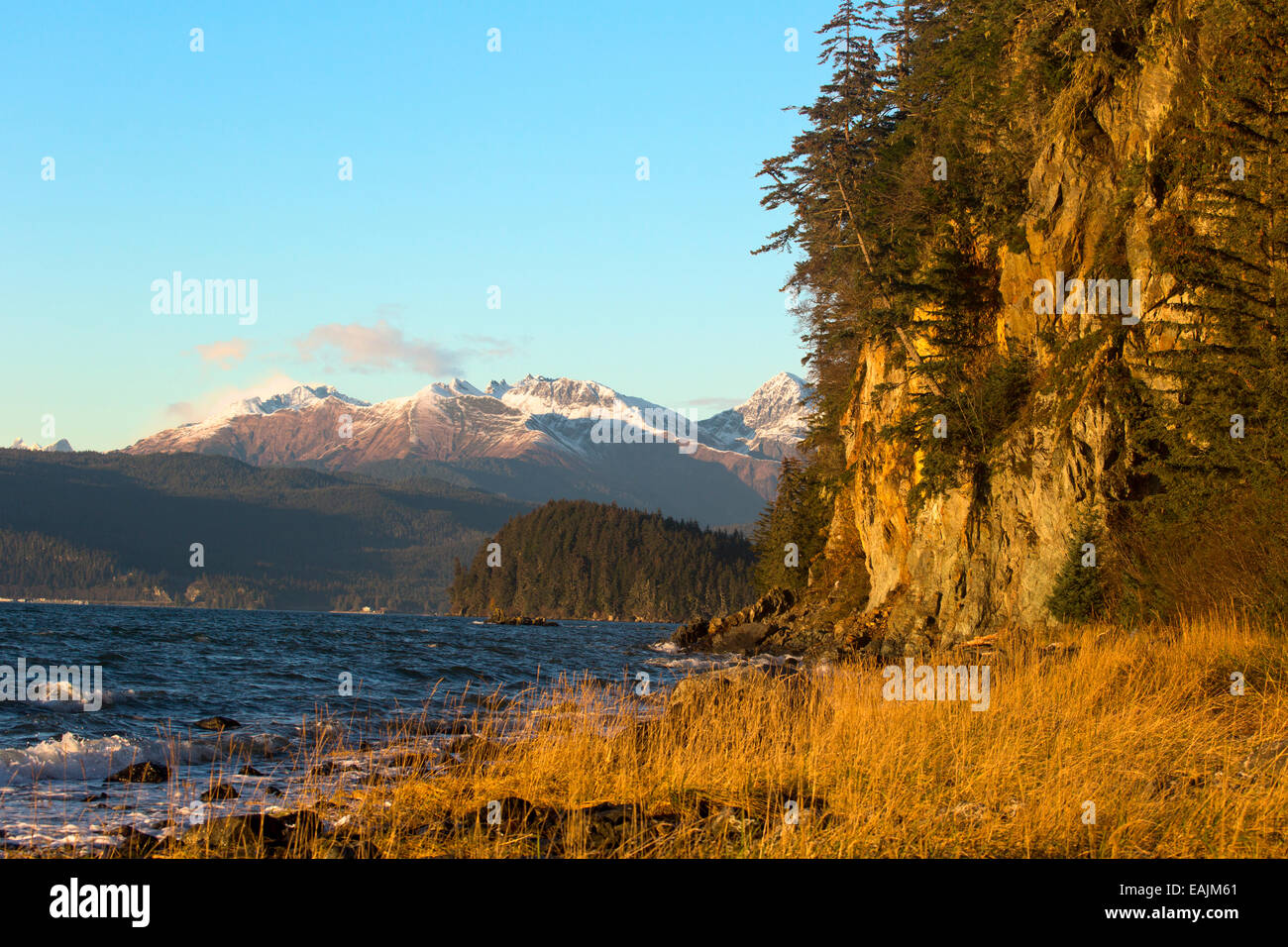 Sunlight highlights autumn colors of Fritz Cove on northwestern coast of Douglas Island, Juneau, Alaska. Stock Photo