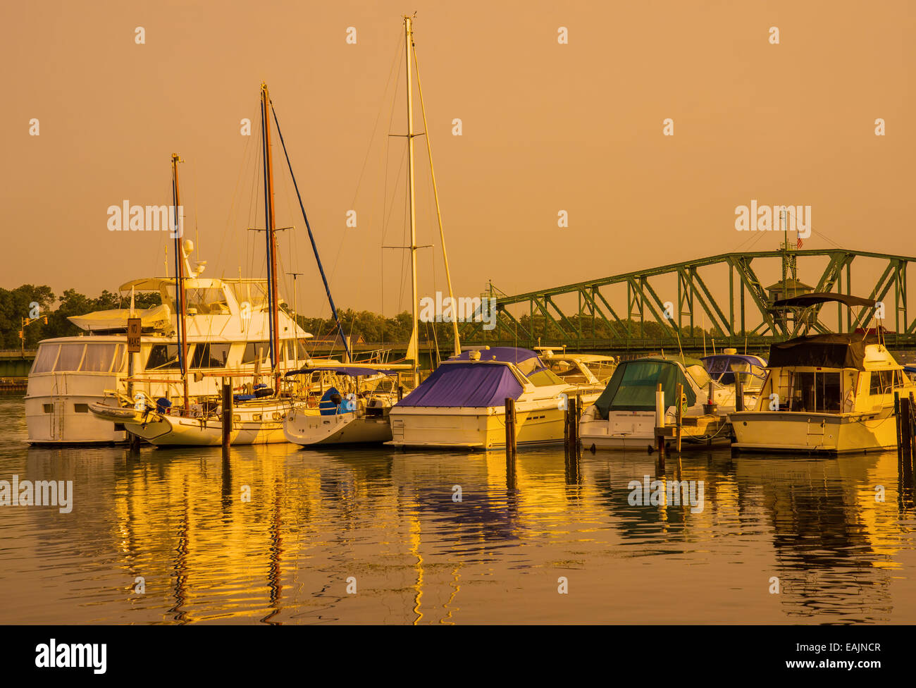 Golden glow on marina boats and water Stock Photo