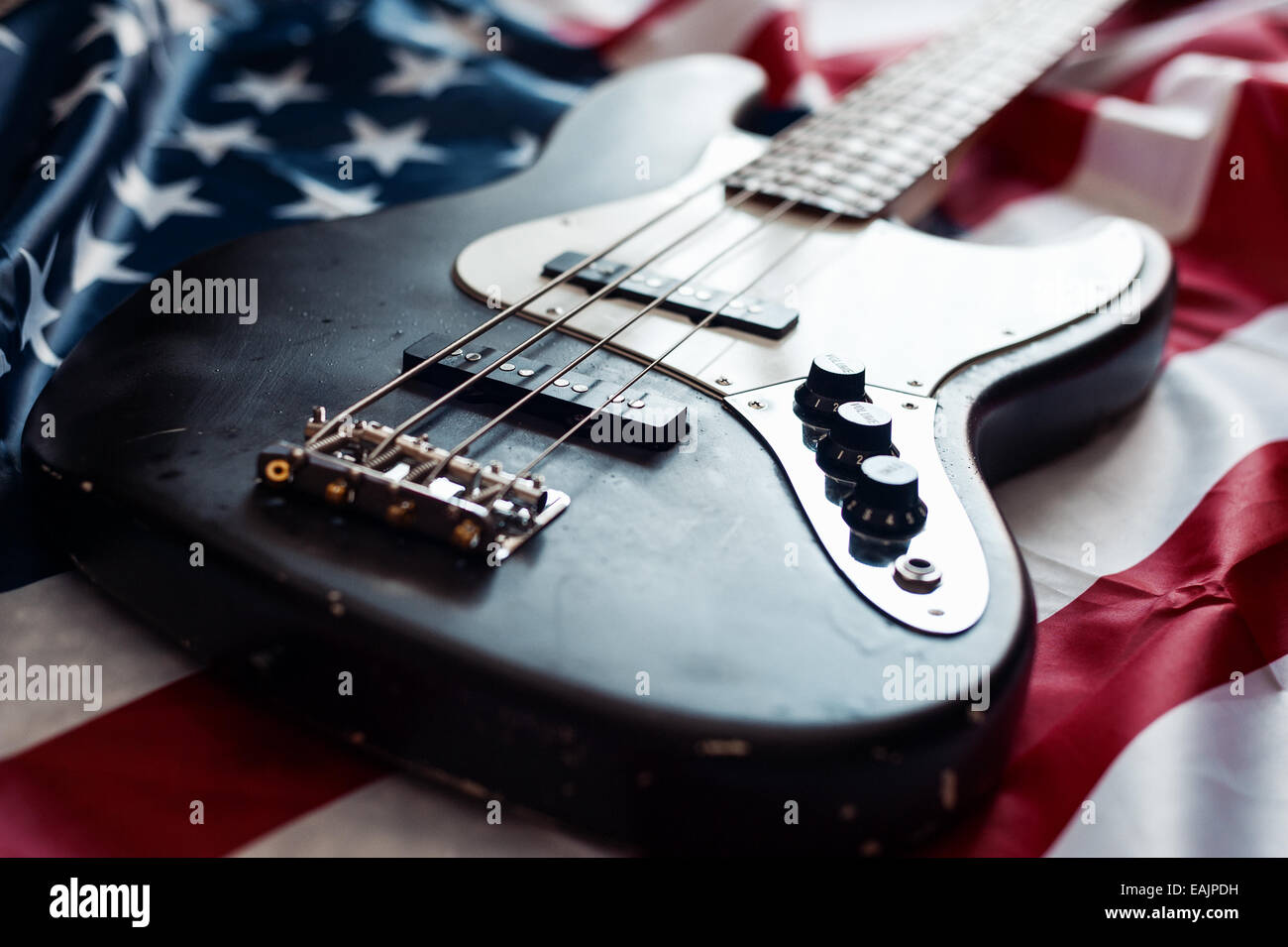 Vintage four string bass guitar on American flag background Stock Photo