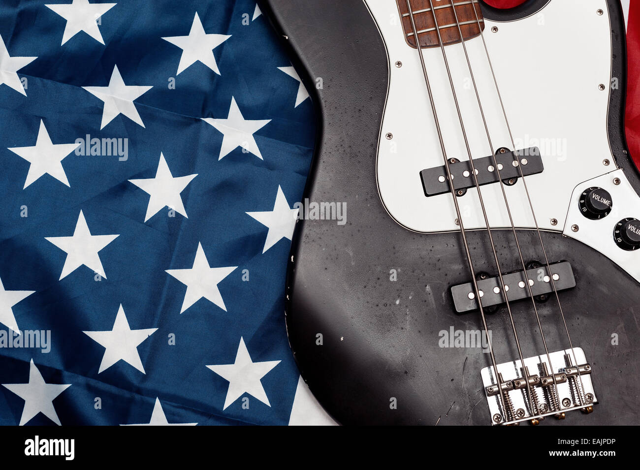 Vintage four string bass guitar on American flag background Stock Photo