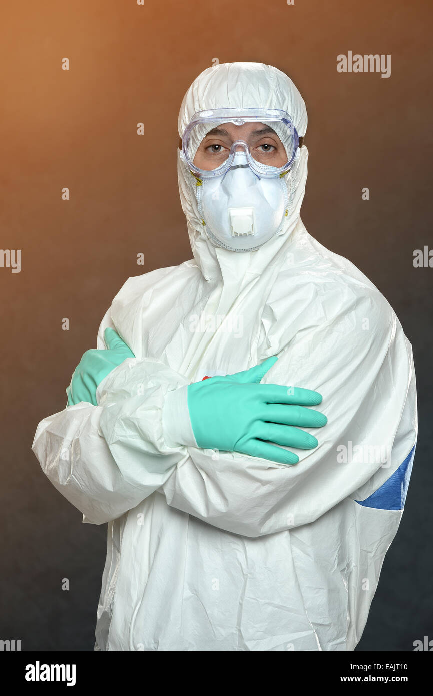 Scientist in Hazmat suit and protective gear with arms crossed Stock Photo