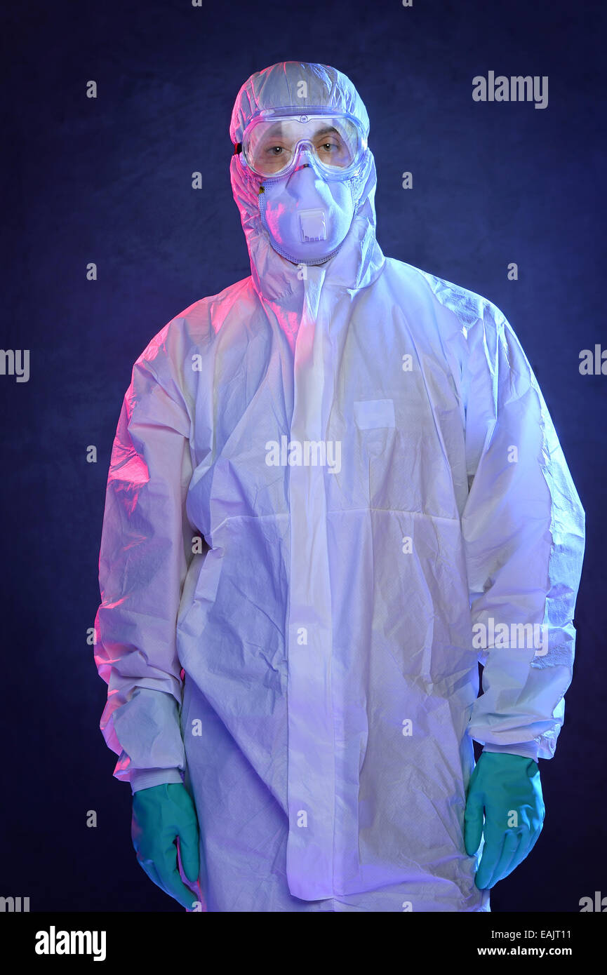 Scientist in Hazmat suit and protective gear over blue background Stock Photo