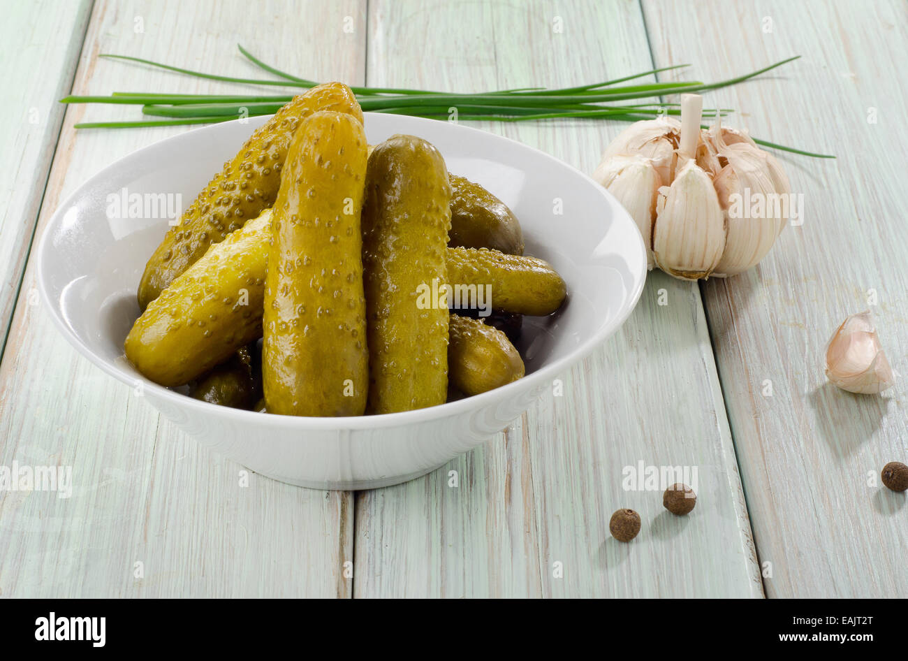 pickled cucumbers in a white bowl . Selective focus Stock Photo