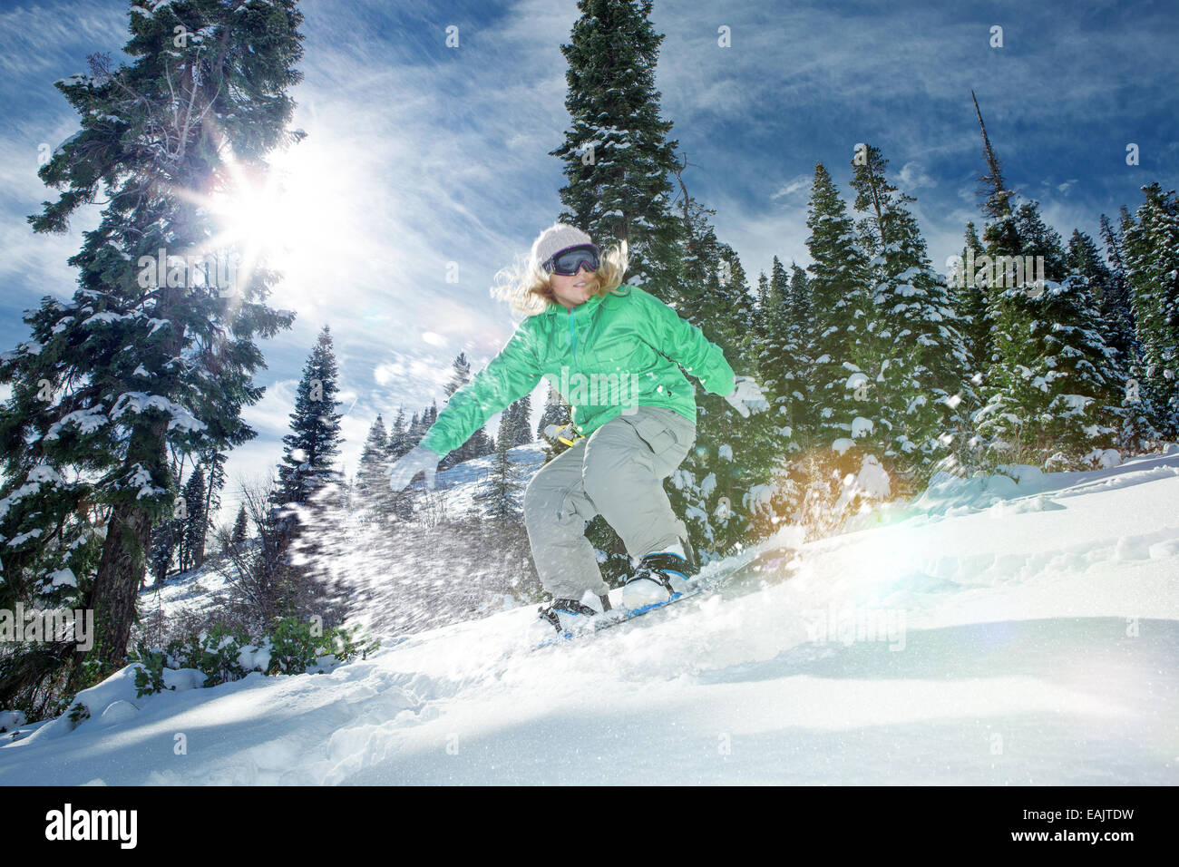 view of a young girl snowboarding in winter environment Stock Photo