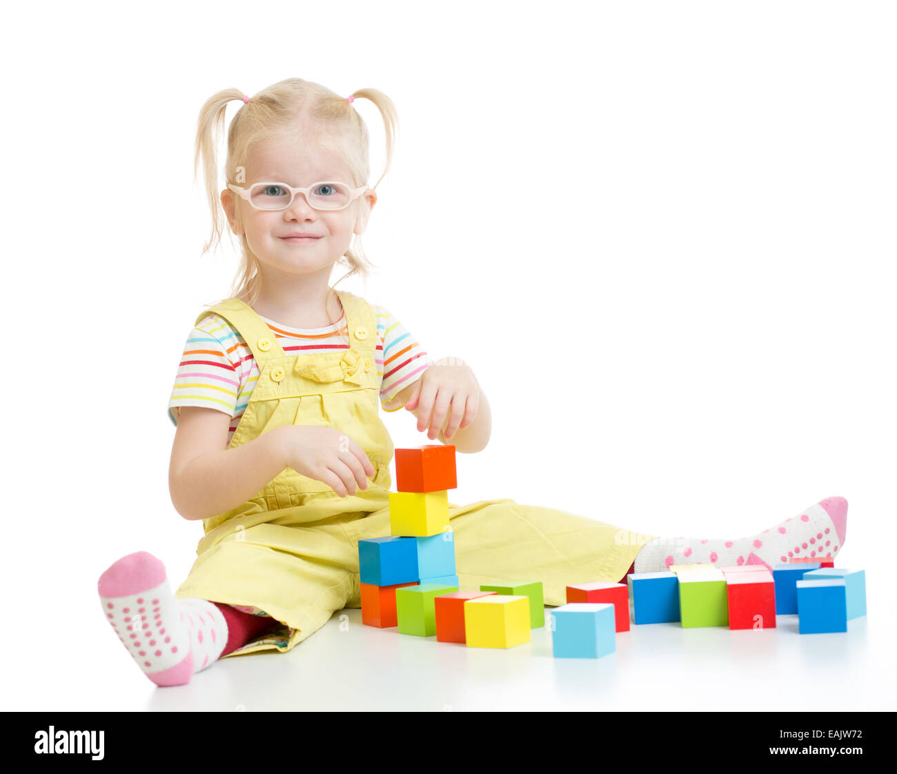 Funny kid in eyeglases playing building blocks isolated Stock Photo