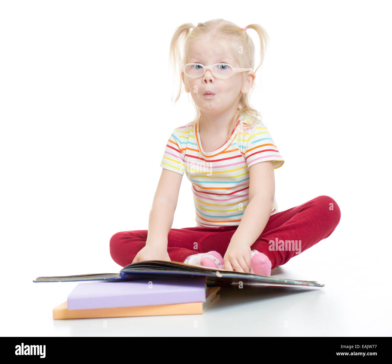 Funny child in eyeglases reading book isolated Stock Photo