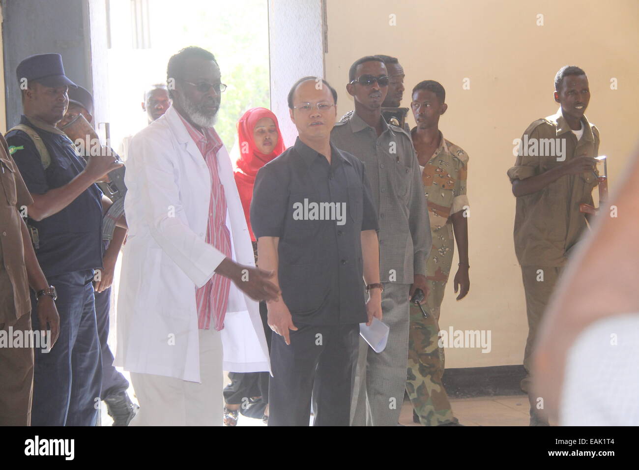 (141117) -- MOGADISHU, Nov. 17, 2014 (Xinhua) -- Chinese Ambassador to Somalia, Wei Hongtian (Front, 2nd L) is seen during the donation ceremony in Mogadishu, capital of Somalia, Nov. 15, 2014. The Chinese embassy in Somalia on Saturday donated aid stuff to a hospital in Mogadishu. The aid stuff, consisting of food, drinks, medicines and tanks of fuel, was delivered to Banadir Mother and Child Hospital, which was built for Somalia by the Chinese government in 1970s. (Xinhua/Faisal Isse) Stock Photo