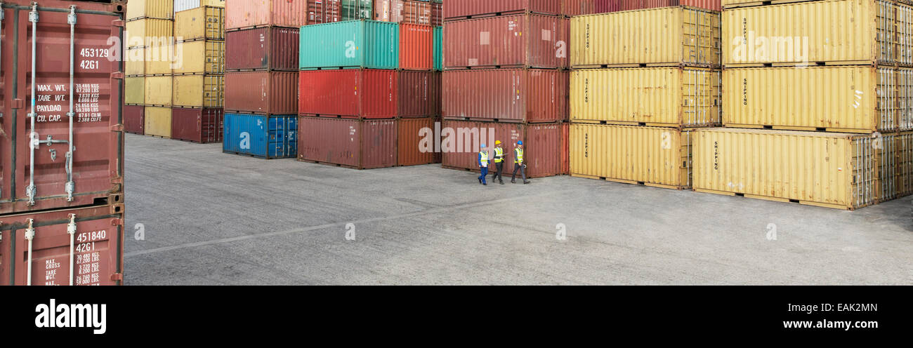 Workers walking near cargo containers Stock Photo - Alamy