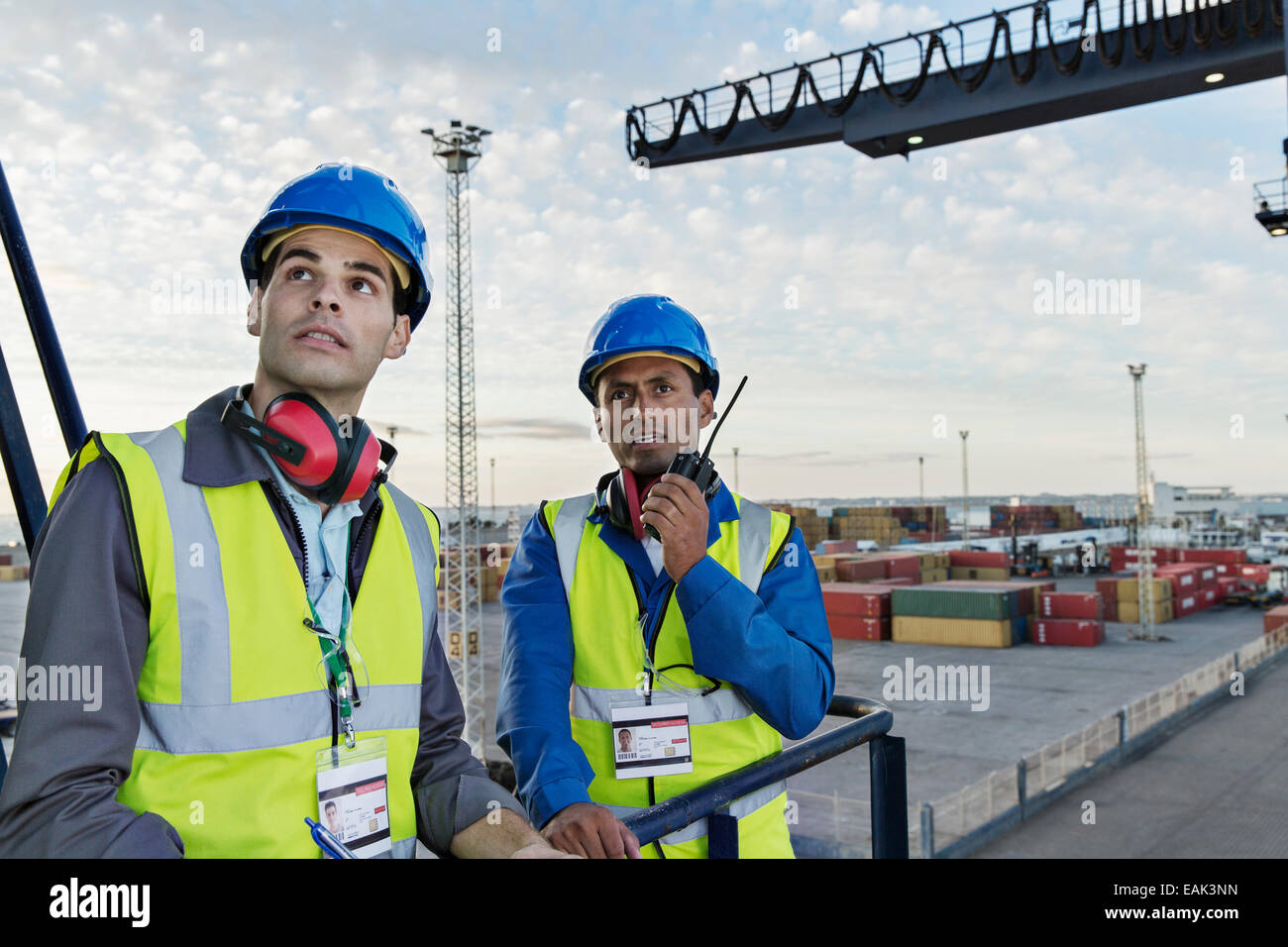 Workers standing on cargo crane Stock Photo