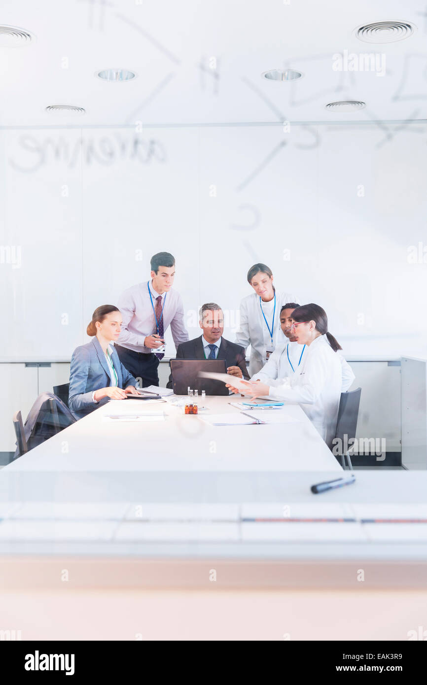 Scientists and business people talking in conference room Stock Photo