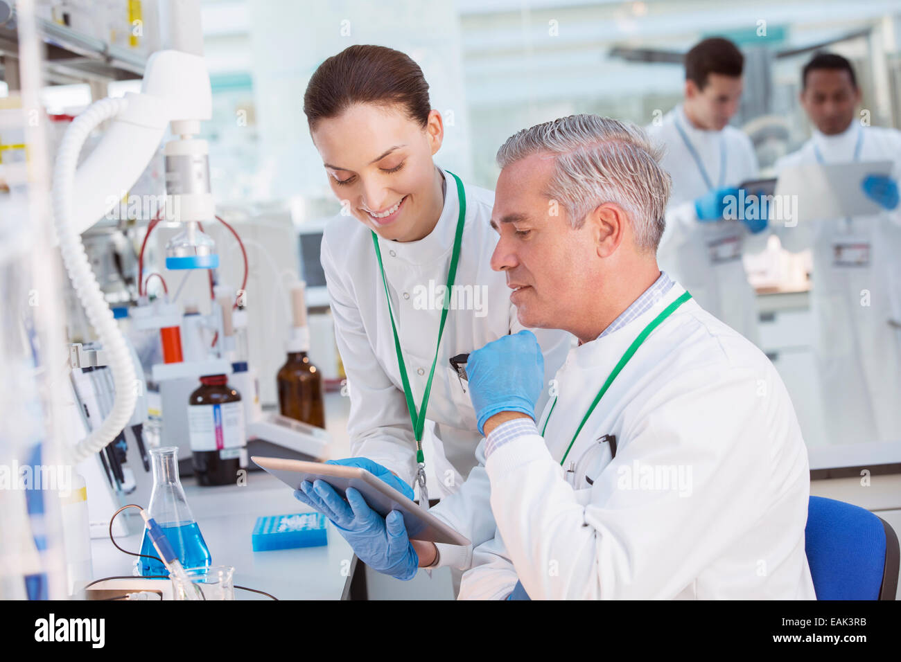 Scientists using tablet computer in laboratory Stock Photo