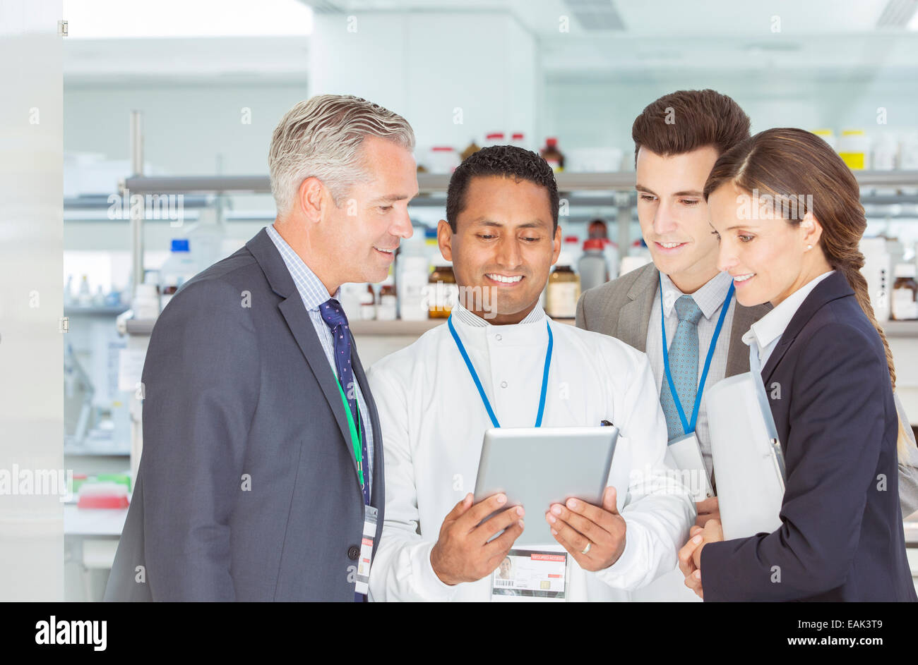 Scientist and business people using digital tablet in laboratory Stock Photo