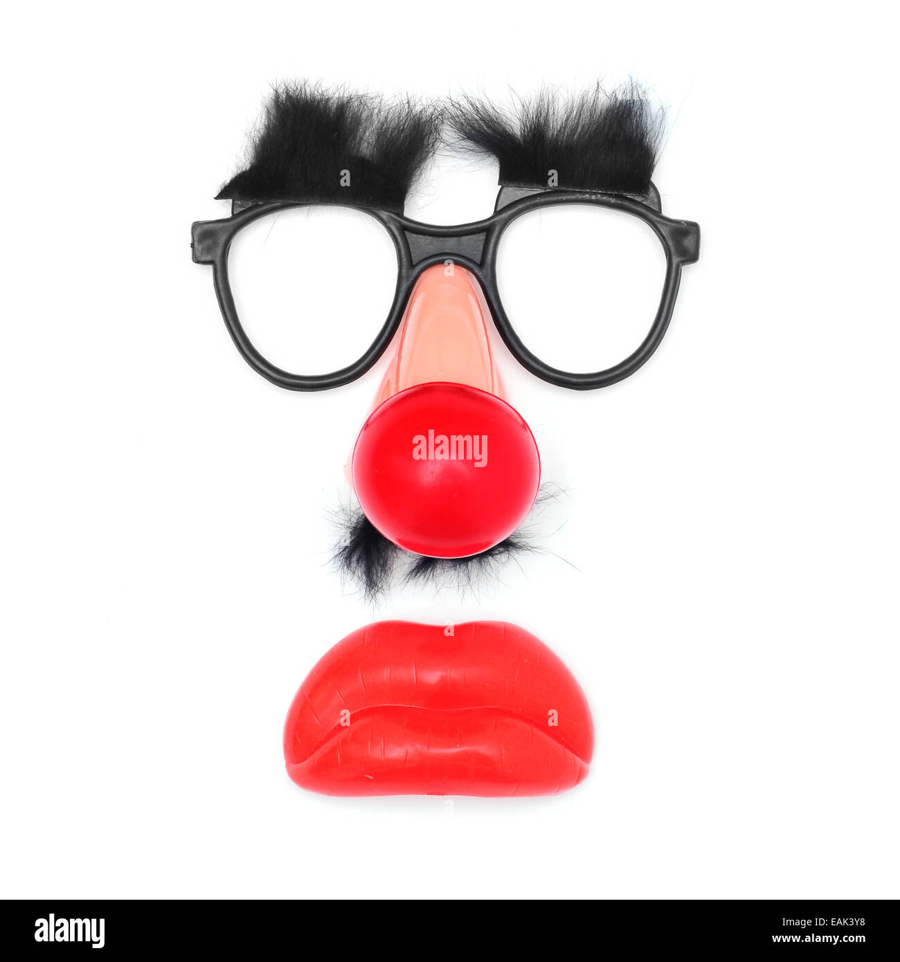 funny face: fake glasses and eyebrows, clown nose, mustache and mouth on a white background Stock Photo