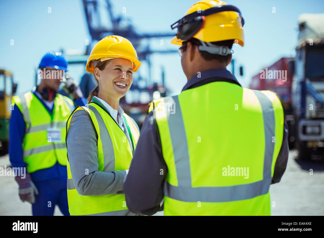 Business people wearing protective workwear talking Stock Photo