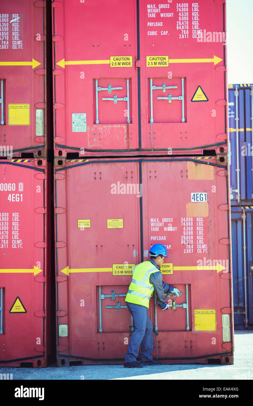 Worker opening cargo container Stock Photo