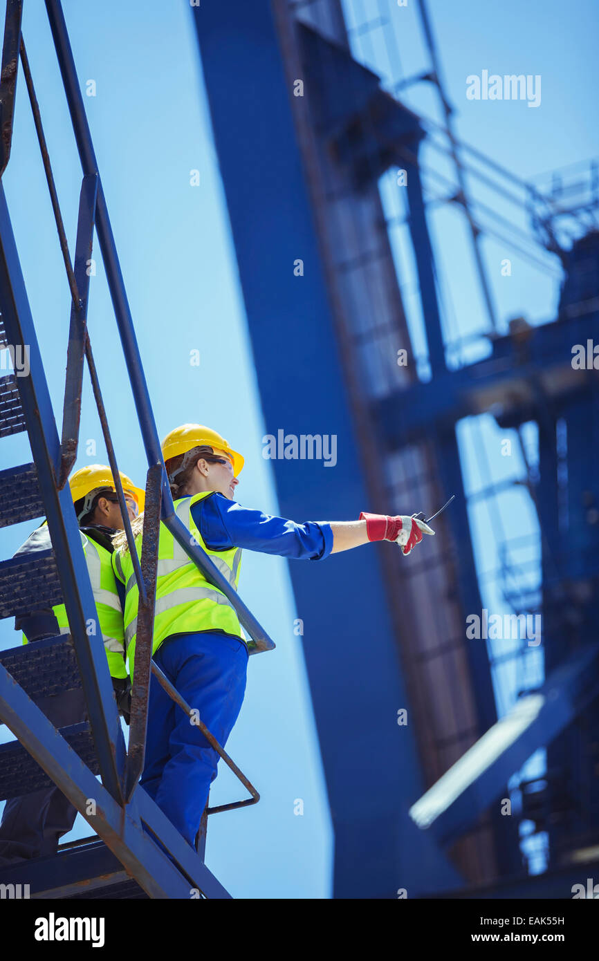 Low angle view of workers on cargo crane Stock Photo