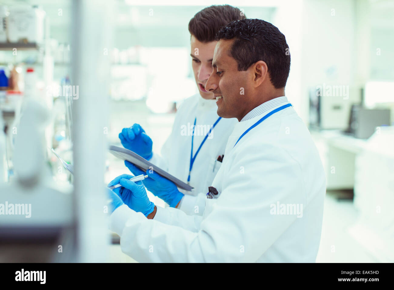 Scientists using digital tablet in laboratory Stock Photo