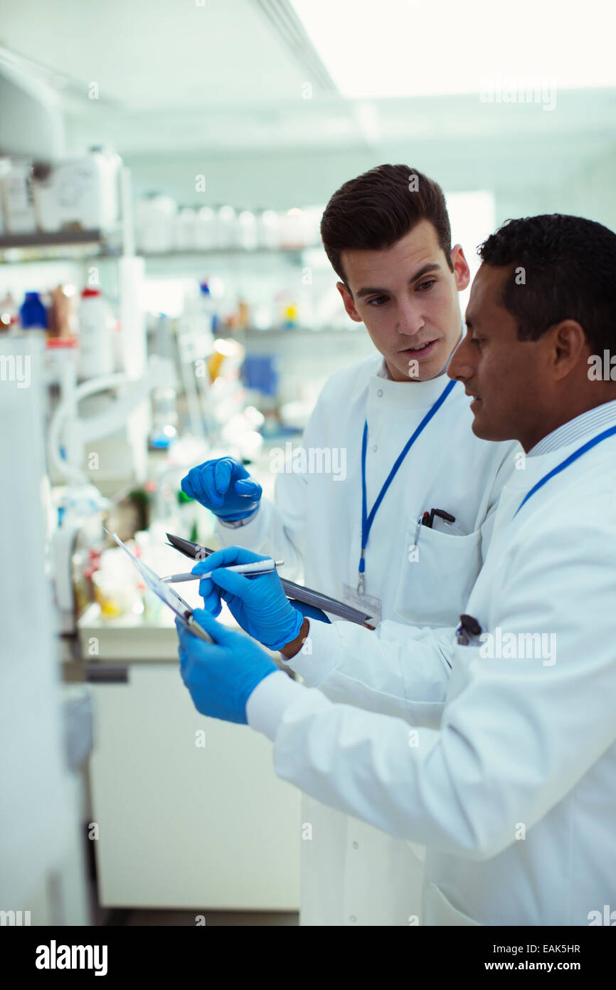Scientists taking notes in laboratory Stock Photo